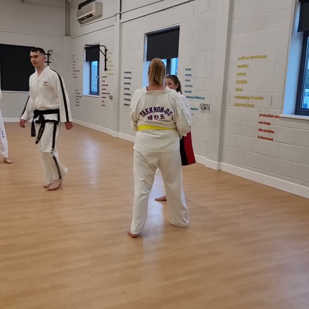 Swain Taekwon-Do students training with kick shields in the dance studio