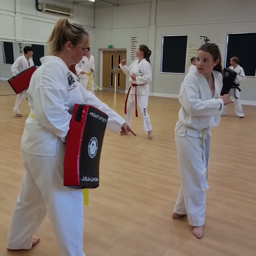 Students holding kick shields during a Swain Taekwon-Do class